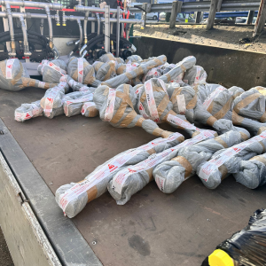Photo of 19 fuel tank heaters wrapped and labelled laying on flatbed lorry.