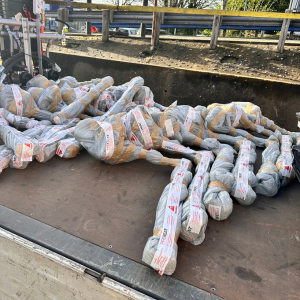 Photo of 19 fuel tank heaters wrapped and labelled laying on flatbed lorry.