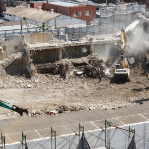 Photo of a crane demolishing a structure on a building site.
