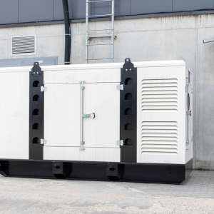 Photo of a white power generator infront of a wall.