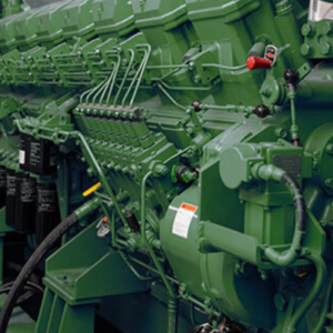 An photo of a green engine on a diesel power generator.
