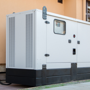 Image of a white generator against a peach coloured wall.