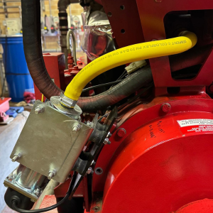 A closer Image of a fitting plate on Peregrine fire pump heater that has been installed on fire pump engine.
